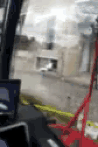 a blurry picture of a car driving down a street with a building in the background .