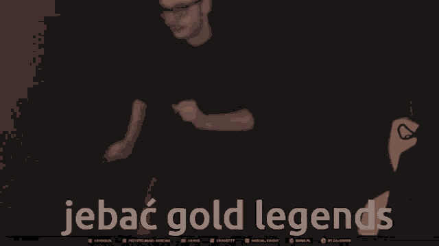 a man in a dark room with the words jebac gold legends written on the bottom
