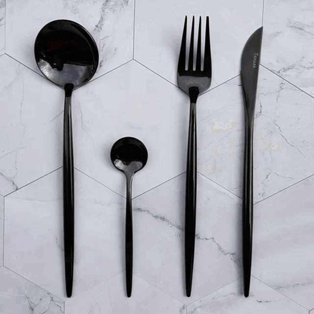 two wine glasses are sitting on top of a black plate on a table .