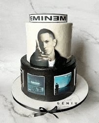 a cake with a picture of eminem on it is sitting on a table .