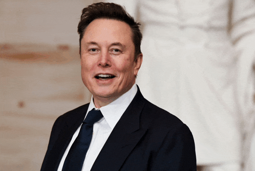 a man wearing a suit and tie is smiling for the camera