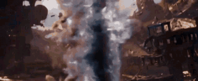 a large explosion is taking place in the middle of a city in a movie .