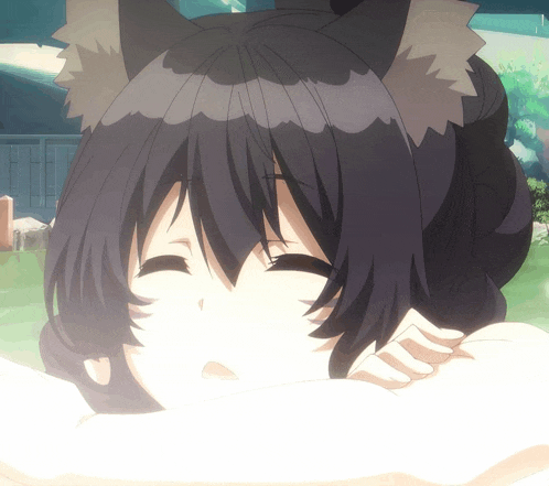 a girl with a cat ear is laying down with her eyes closed
