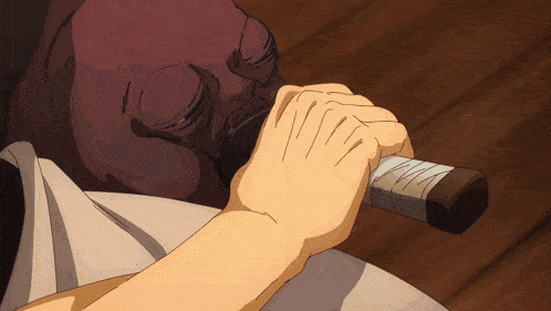 a person is holding a sword with a bandage on the handle