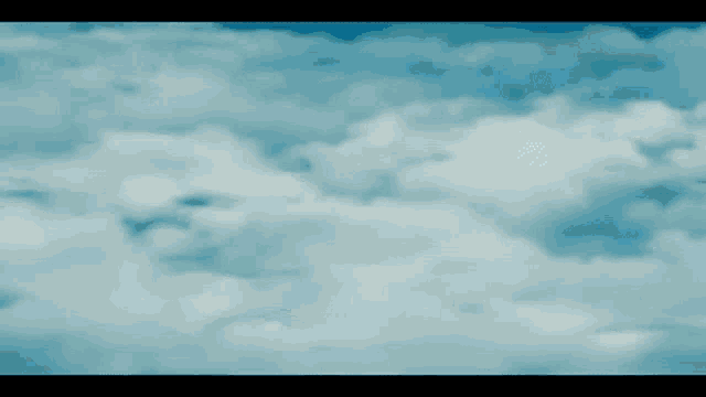 a superhero is flying through the air with a wave coming out of his hand