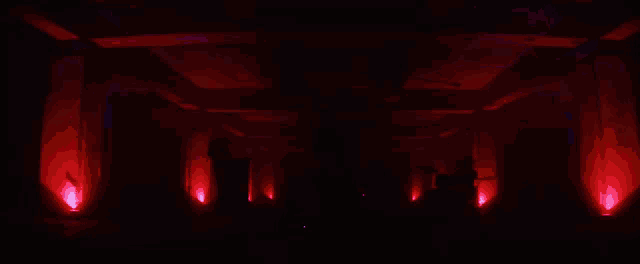 a man is playing a guitar on a stage with blue lights