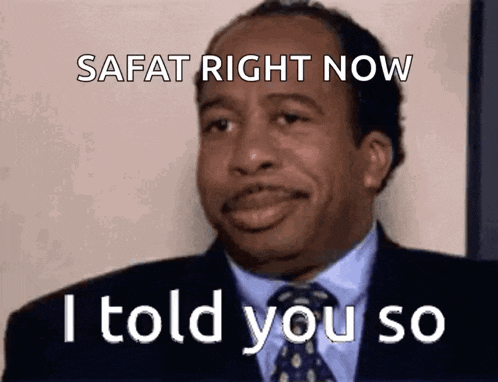 a man in a suit and tie is making a funny face and saying safat right now i told you so .