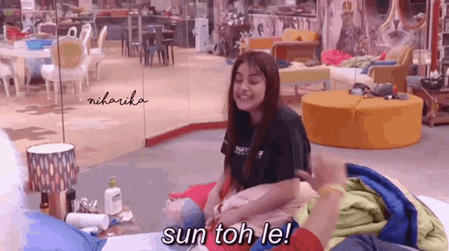a woman sits on a bed with the words sun toh le written on the bottom
