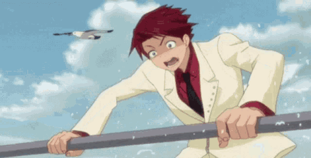 a man in a white suit and red tie is holding onto a pole