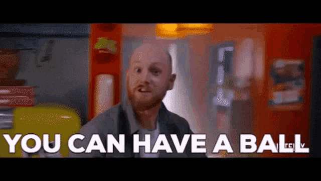 a bald man with a beard is saying `` you can have a ball '' in a kitchen .