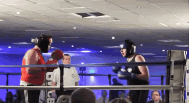 two boxers are fighting in a ring and one of them is wearing a shirt that says bbc