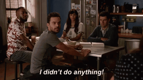 a group of people sitting around a table with a man saying i did n't do anything