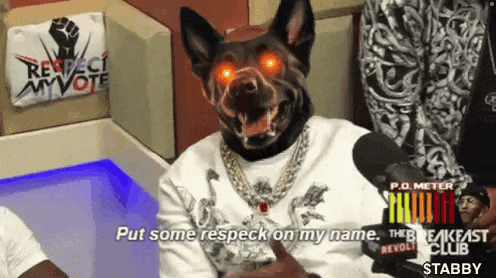 a man wearing a dog mask is talking into a microphone .