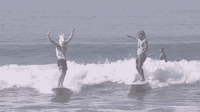 a man wearing a unicorn hat is riding a wave