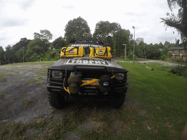 a trophy jeep is parked in the grass