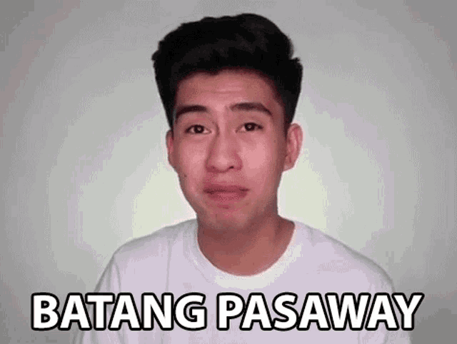 a young man in a white shirt is making a funny face and says batang pasaway .