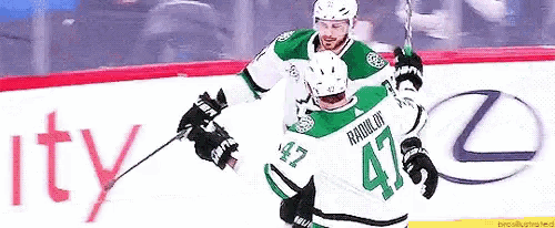 a hockey player with the number 47 on his jersey is holding a stick .