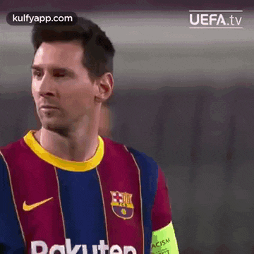 a close up of a soccer player wearing a barcelona jersey