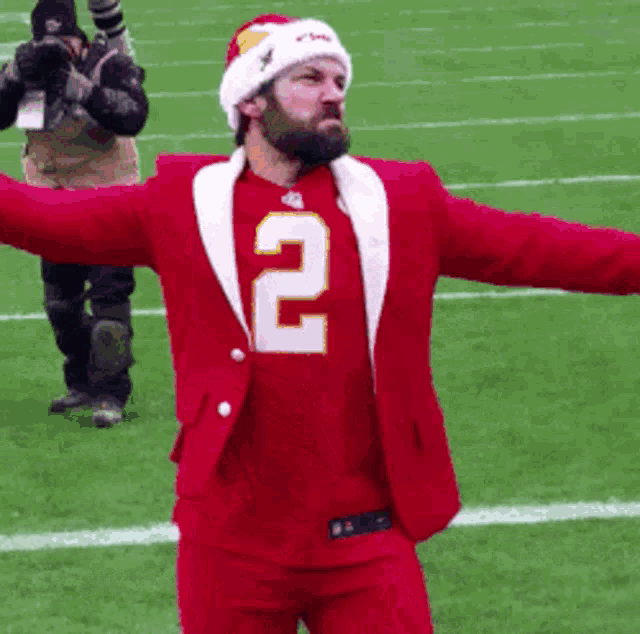 a man in a red suit with the number 2 on his jersey