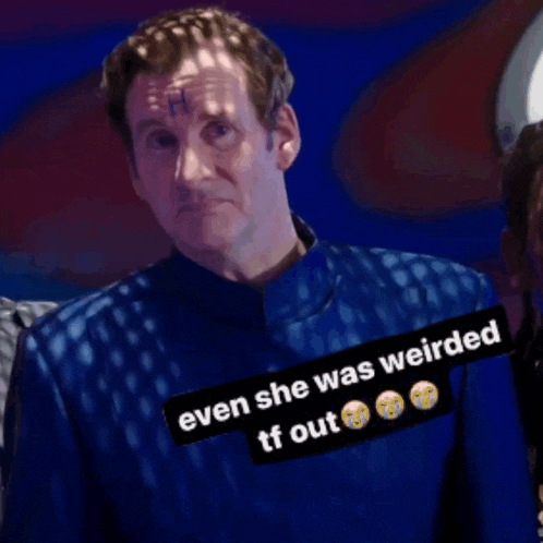 a man in a blue shirt has a sticker that says even she was weirded tf out