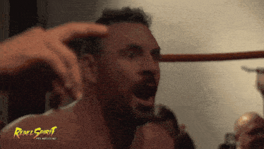 a man with a rebel spirit pro wrestling logo on his face