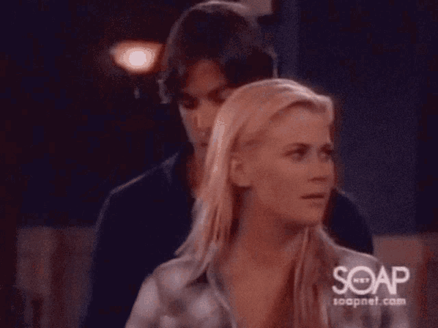 a man kissing a woman on the forehead with soapnet.com written on the bottom