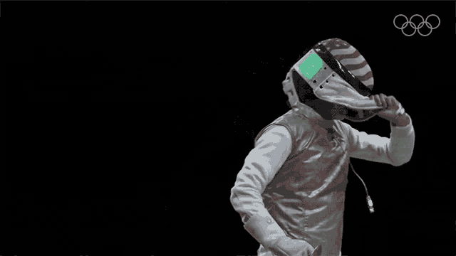 a woman in a fencing uniform is holding a sword in front of a black background with the olympic rings on it