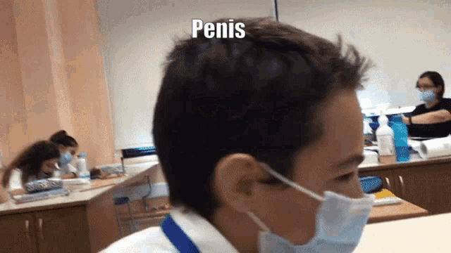 a man wearing a mask with the word penis on his head