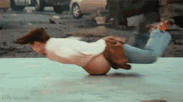 a man is doing a handstand on a concrete floor .