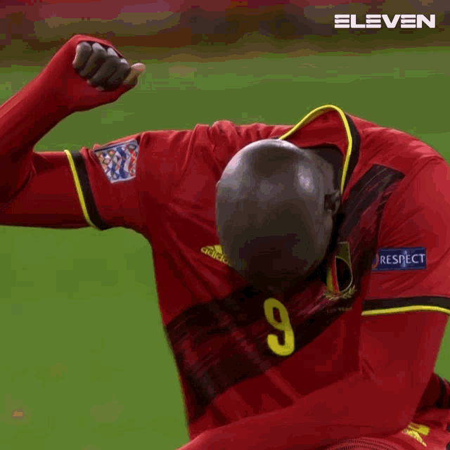 a man in a red adidas jersey with the number 9 on it