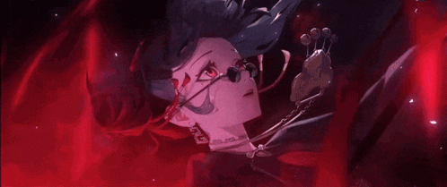 a close up of a person 's face with red eyes .