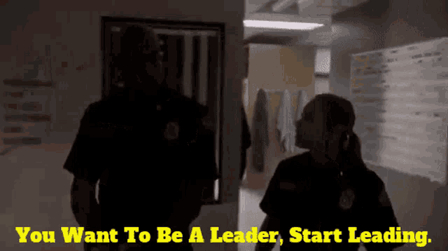 two police officers talking with the words you want to be a leader start leading behind them