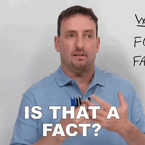 a man says is that a fact in front of a white board