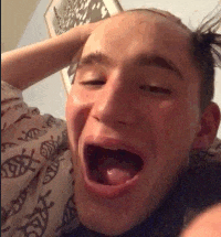 a close up of a man with his mouth open