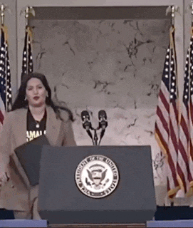 a woman is standing at a podium with the seal of the president of the united states on it