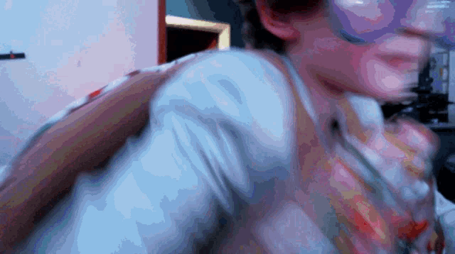 a blurry picture of a person 's face with a purple background