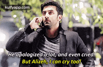 a man in a suit is talking on a cell phone while crying .