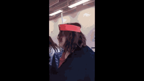 a woman wearing a red hat with the words `` bitch face '' written on it .