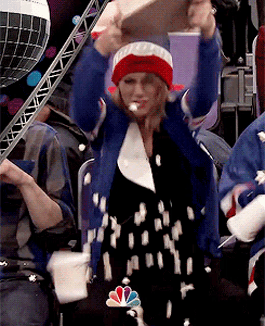 a woman wearing a red white and blue hat with a nbc logo