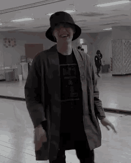 a man wearing a hat and a t-shirt that says a.p.a. on it