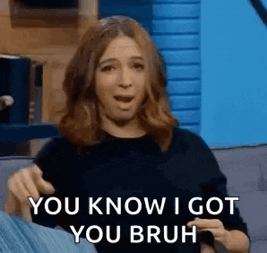 a woman is sitting on a couch and saying `` you know i got you bruh '' while pointing at herself .