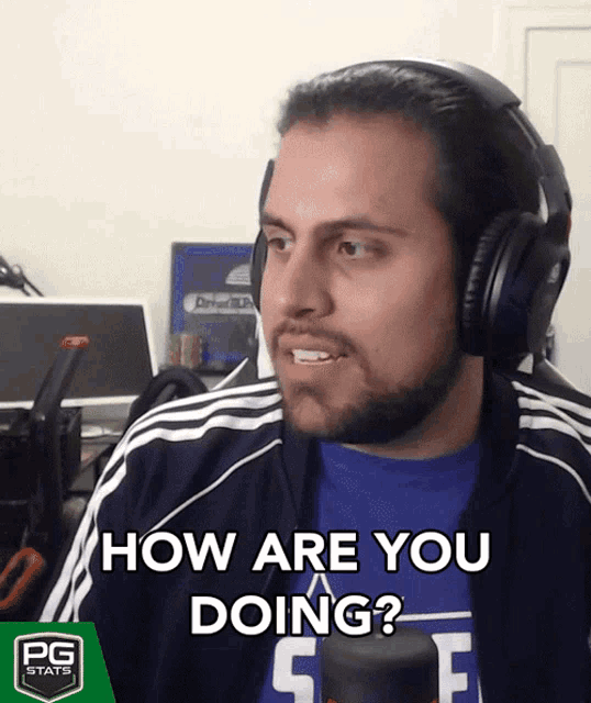 a man wearing headphones and a blue shirt says " how are you doing "