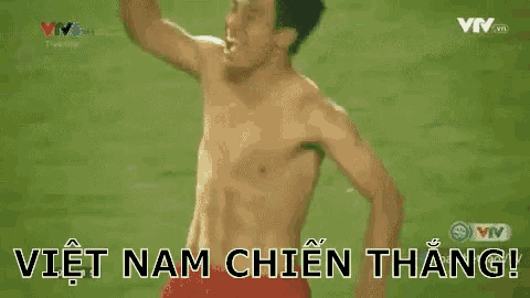 a shirtless man is holding a red towel over his head and says viet nam chien thang .