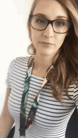 a woman wearing glasses and a lanyard around her neck .