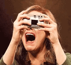 a woman is crying while holding a camera in her hands