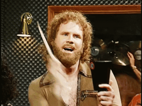 a man with curly hair and a beard is holding a drumstick