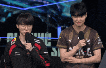 a man speaking into a microphone while wearing a shirt that says samsung