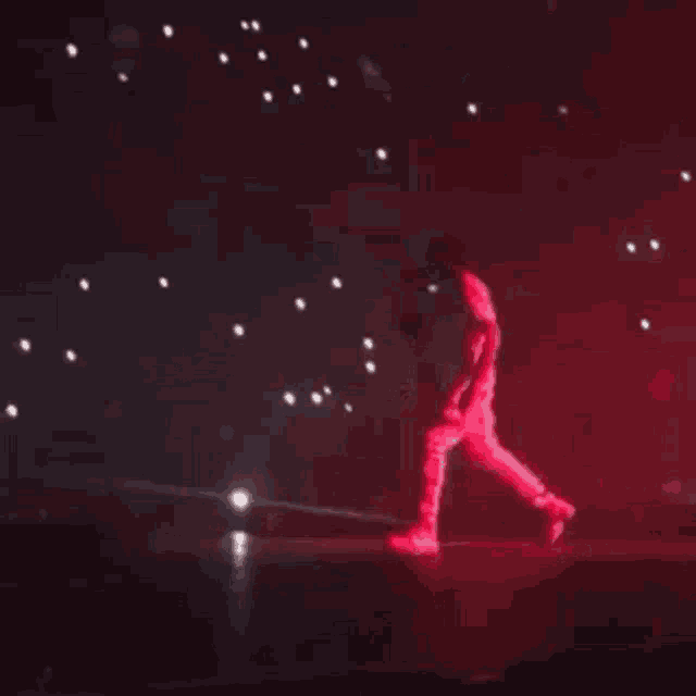 a blurry picture of a stage with a lot of lights coming out of it at night .