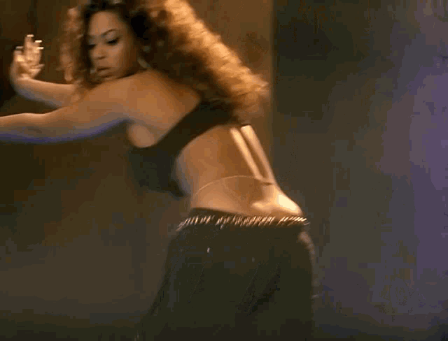 two women are dancing in front of a wall with writing on it that says ' i love you '