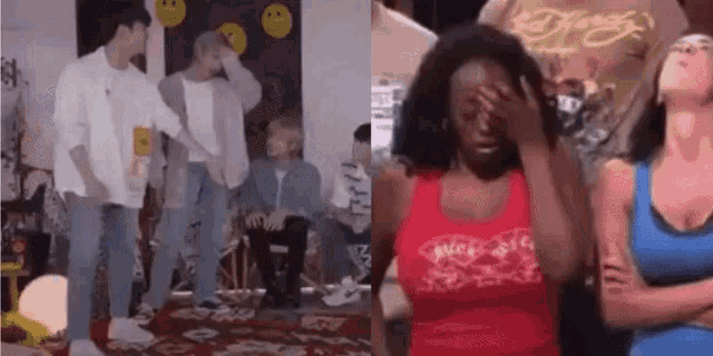 a group of people are standing in a room and a woman is crying .